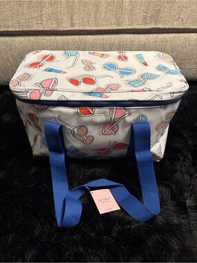 kate spade cream cooler with colorful sunglasses and lipstick print